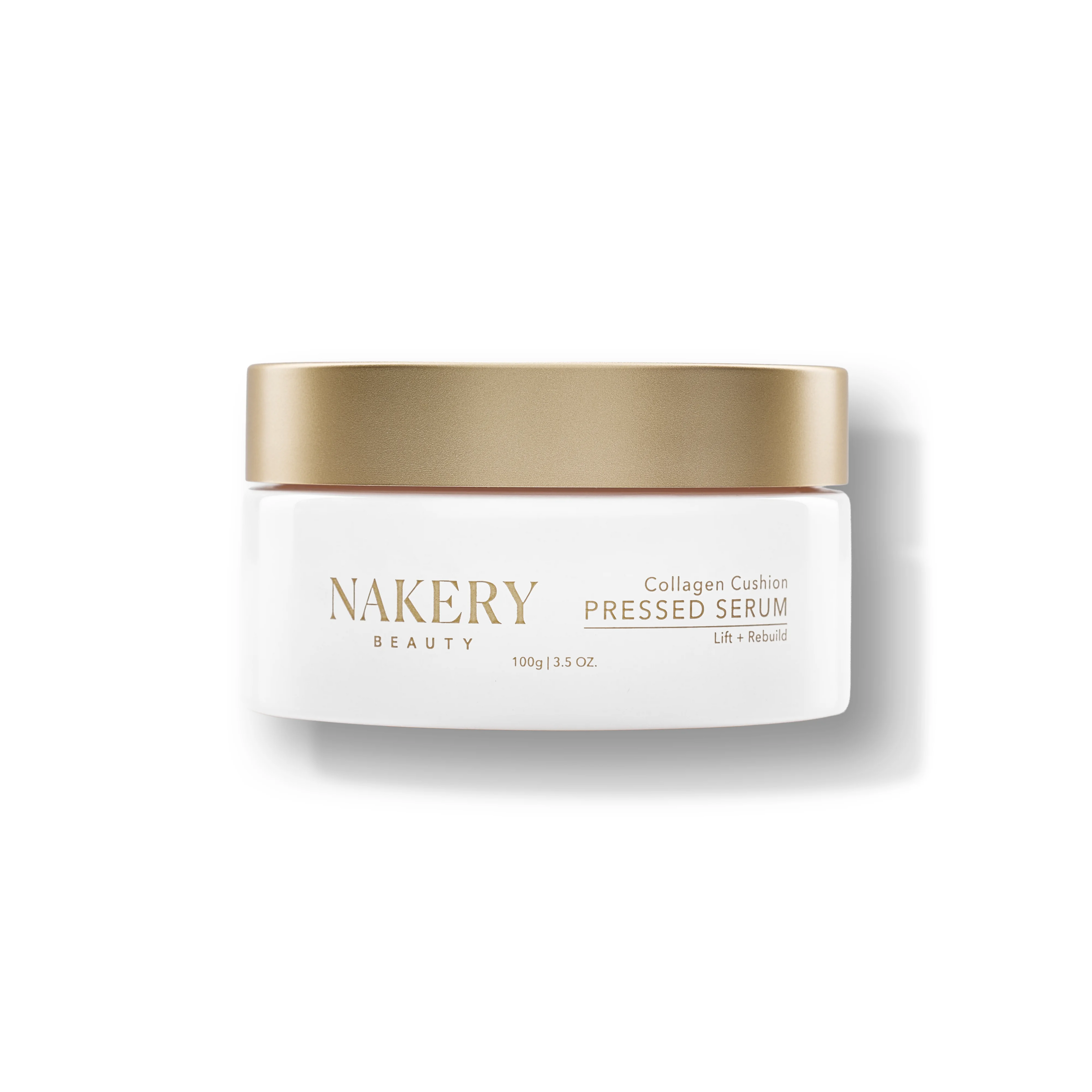 A white cosmetic jar with a metallic gold lid from NAKERY BEAUTY, labeled &