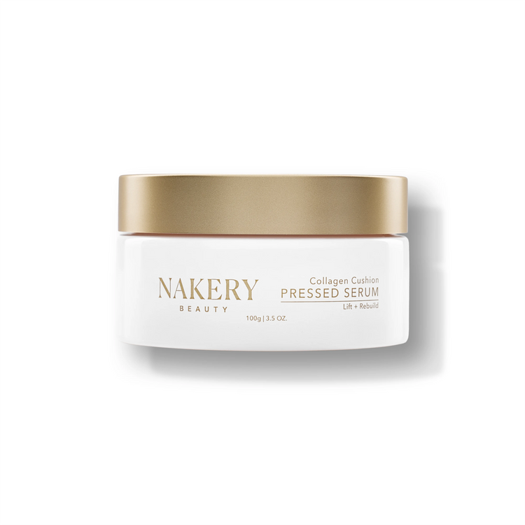 A white cosmetic jar with a metallic gold lid from NAKERY BEAUTY, labeled &