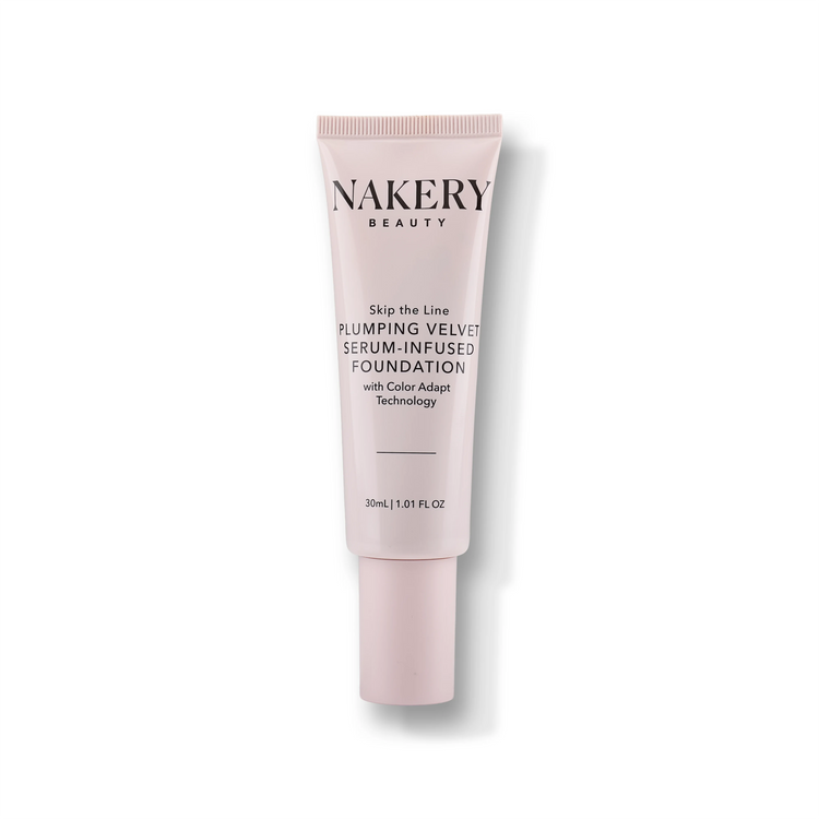 A 30 mL squeeze tube of NAKERY BEAUTY Plumping Velvet Serum-Infused Foundation in a pale pink shade, shown on a clean white background with a soft drop shadow.